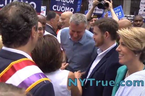 Cuomo, wearing the sash on the left, didn't have a chance to talk to Teachout, the smiling woman standing directly in front of him